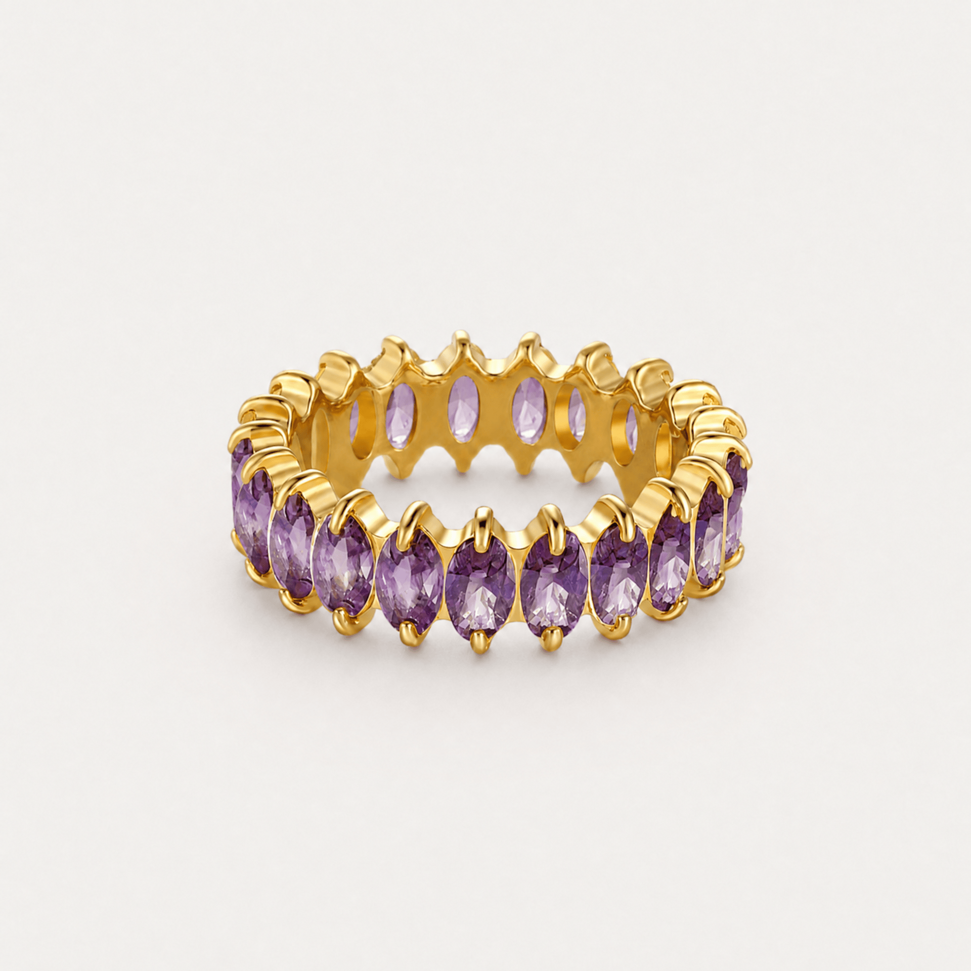 Gold birthstone eternity ring with purple marquise stones, rotating view